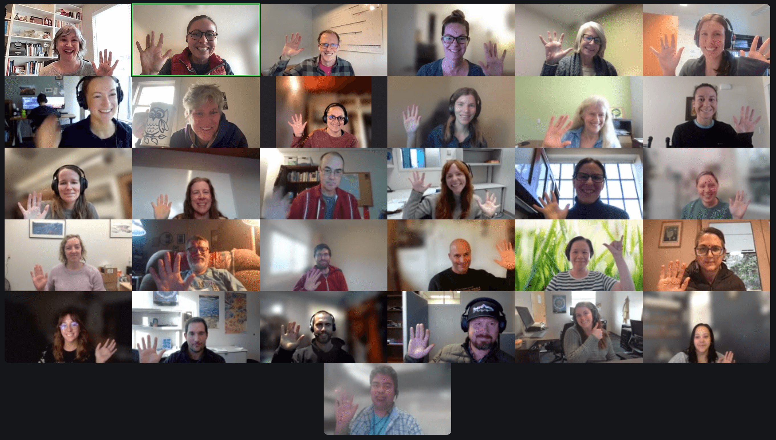 headshots in zoom meeting. a 6 by 6 grid of people smiling and waving