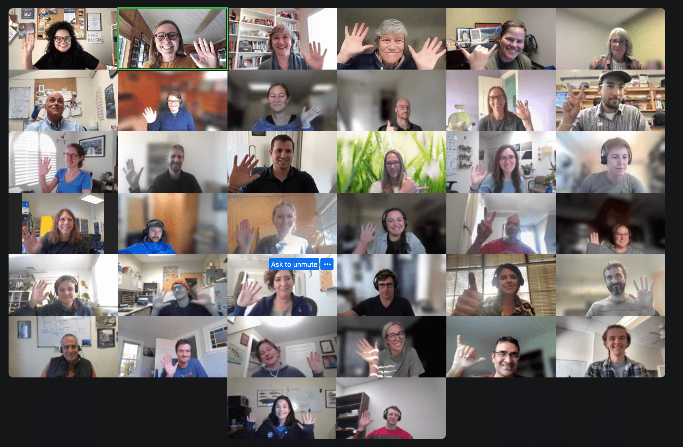 headshots in zoom meeting. a 7 by 6 grid of people smiling and waving